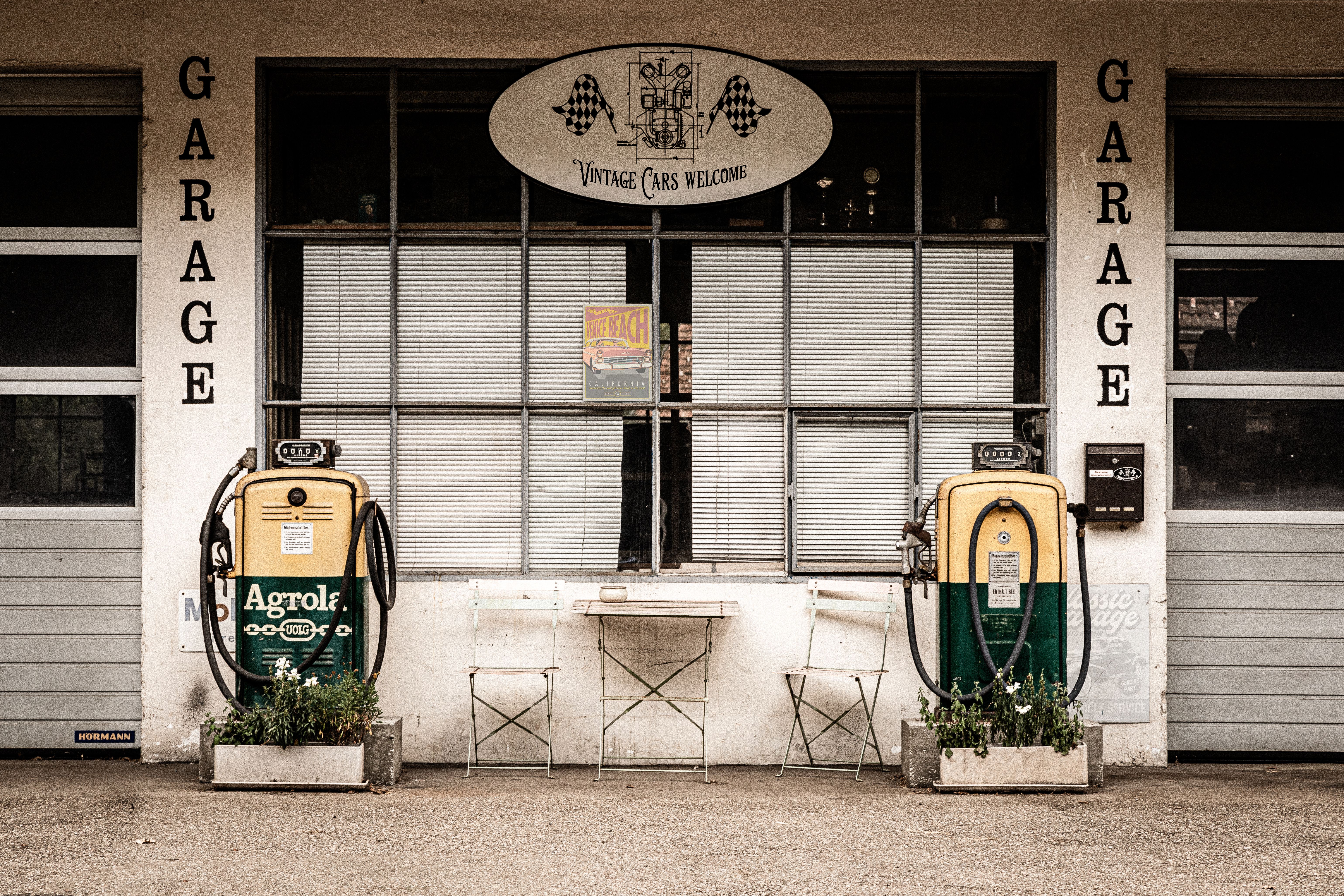Retro garage with vintage gas pumps in Fischenthal, capturing a nostalgic feel.