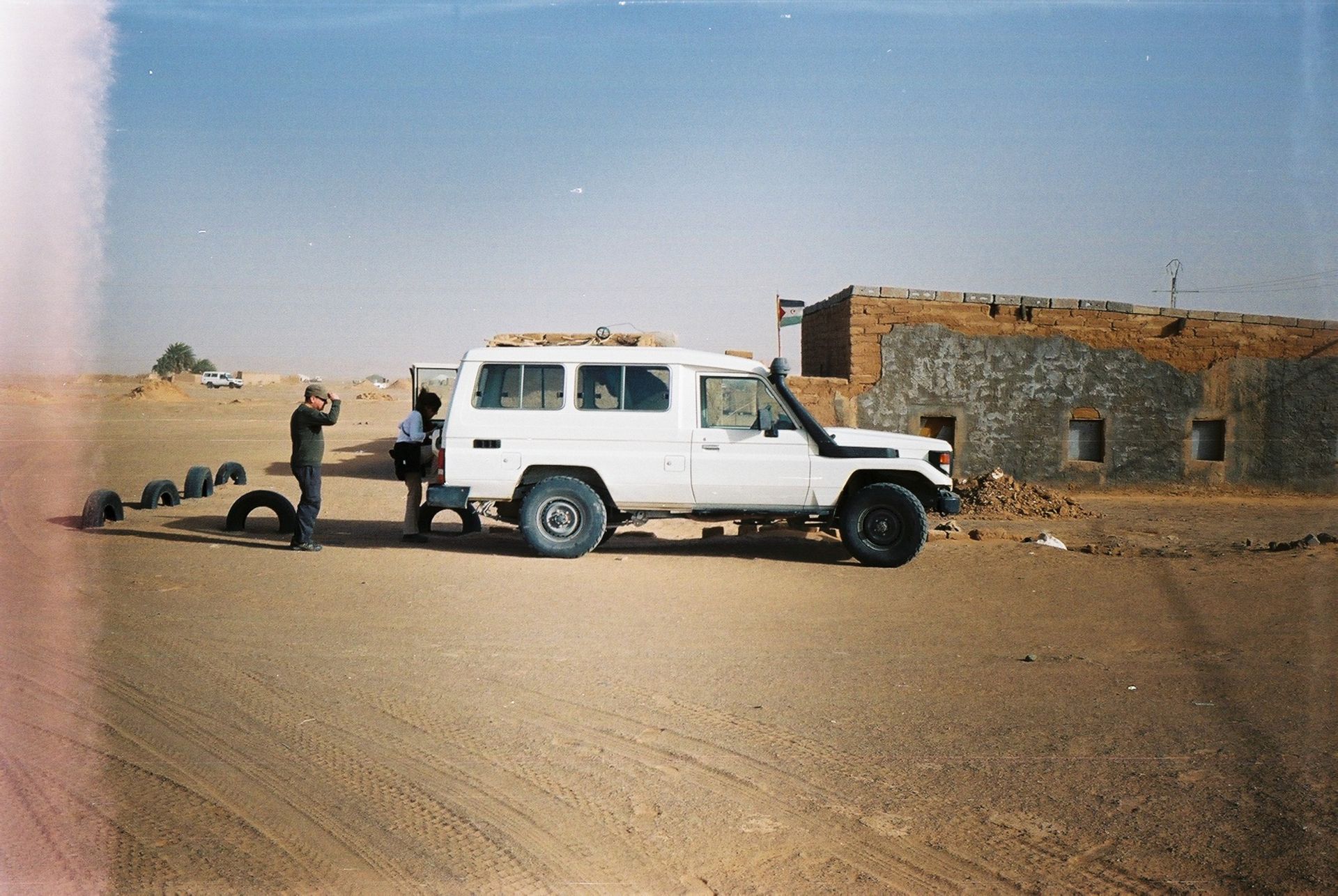 4x4 vehicle parked in the Tindouf desert, Algeria with clear skies.