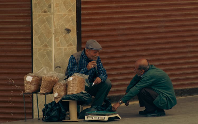 Two Elderly Men On The Street Talking 