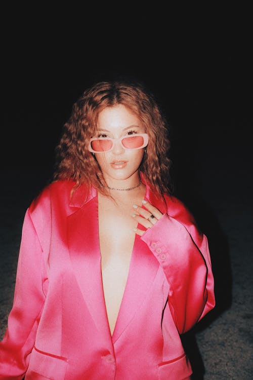 Young Woman in a Pink Blazer and Sunglasses