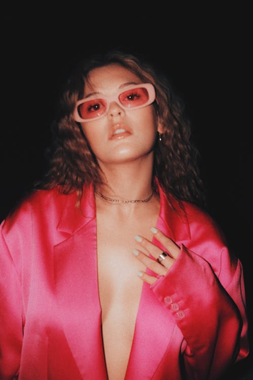 Young Woman in a Pink Blazer and Sunglasses