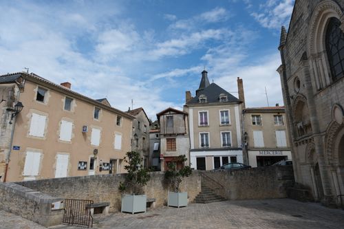 Free Picturesque view of a historic European town square with old buildings and an overcast sky. Stock Photo
