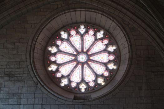 A beautiful circular stained glass window in a historic cathedral, showcasing intricate designs.