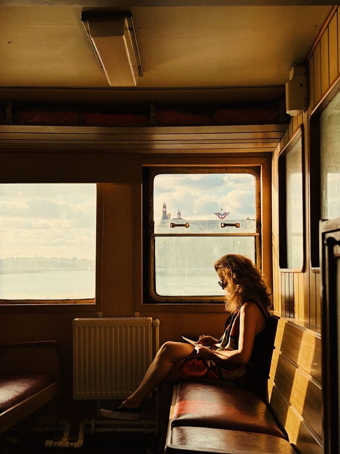 Solo woman traveler enjoying the view from a European train window