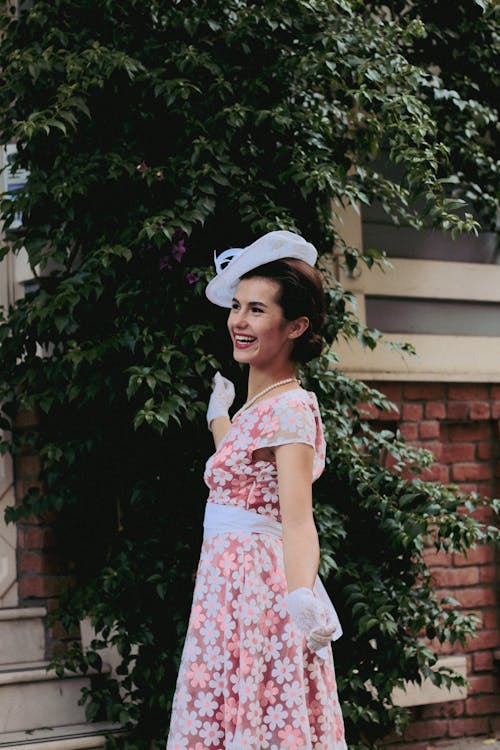 Laughing Brunette Woman in Pink Dress