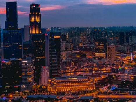 A breathtaking view of Singapore's illuminated cityscape at twilight showcasing modern skyscrapers.