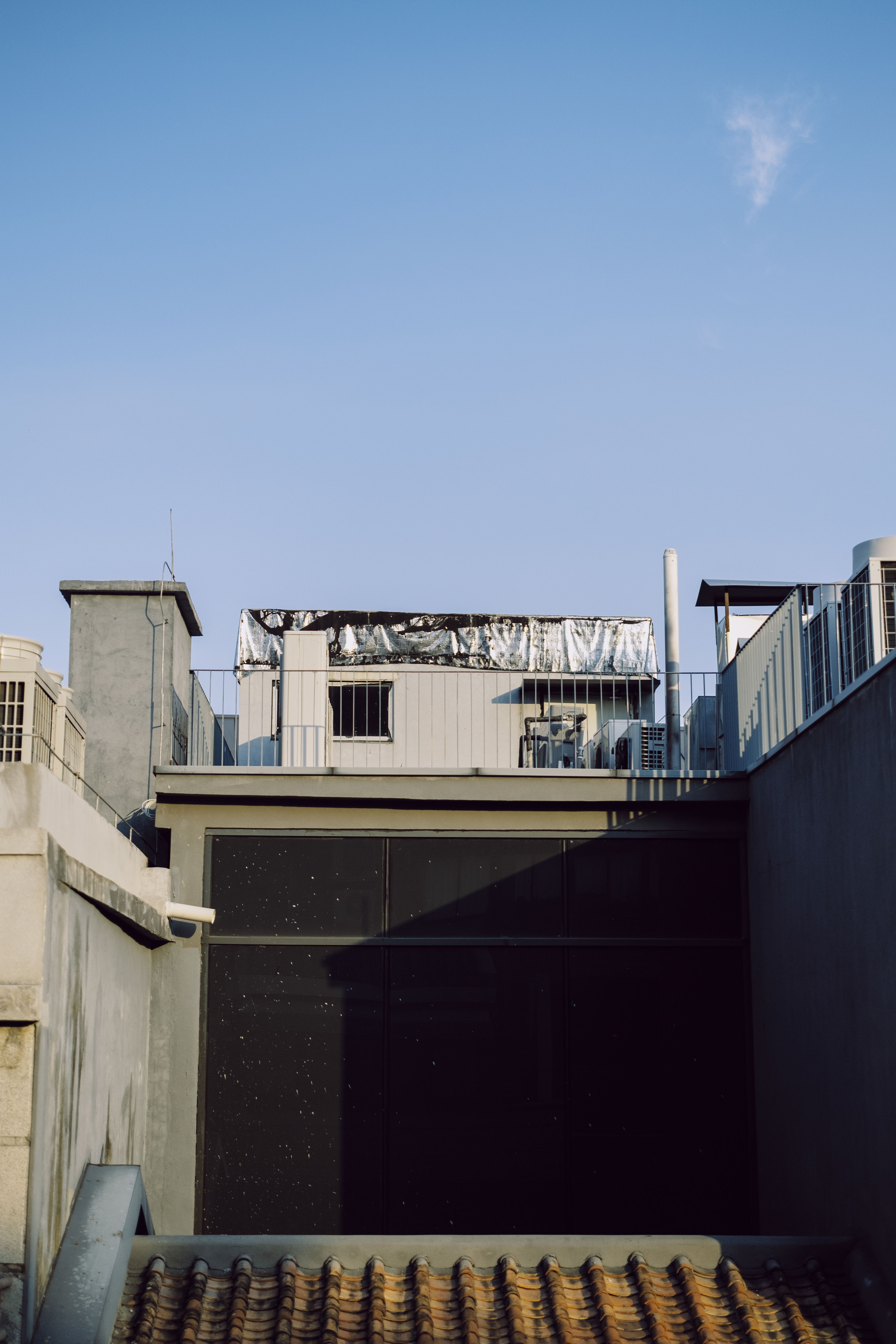 Modern urban rooftops beneath a clear blue sky