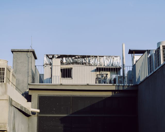 Modern rooftops in the sun Modern urban rooftops beneath a clear blue sky