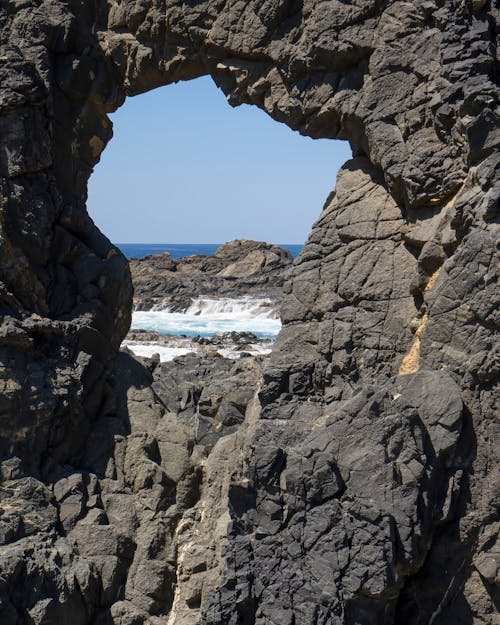 View of the Sea through Hole in a Rock Formations 