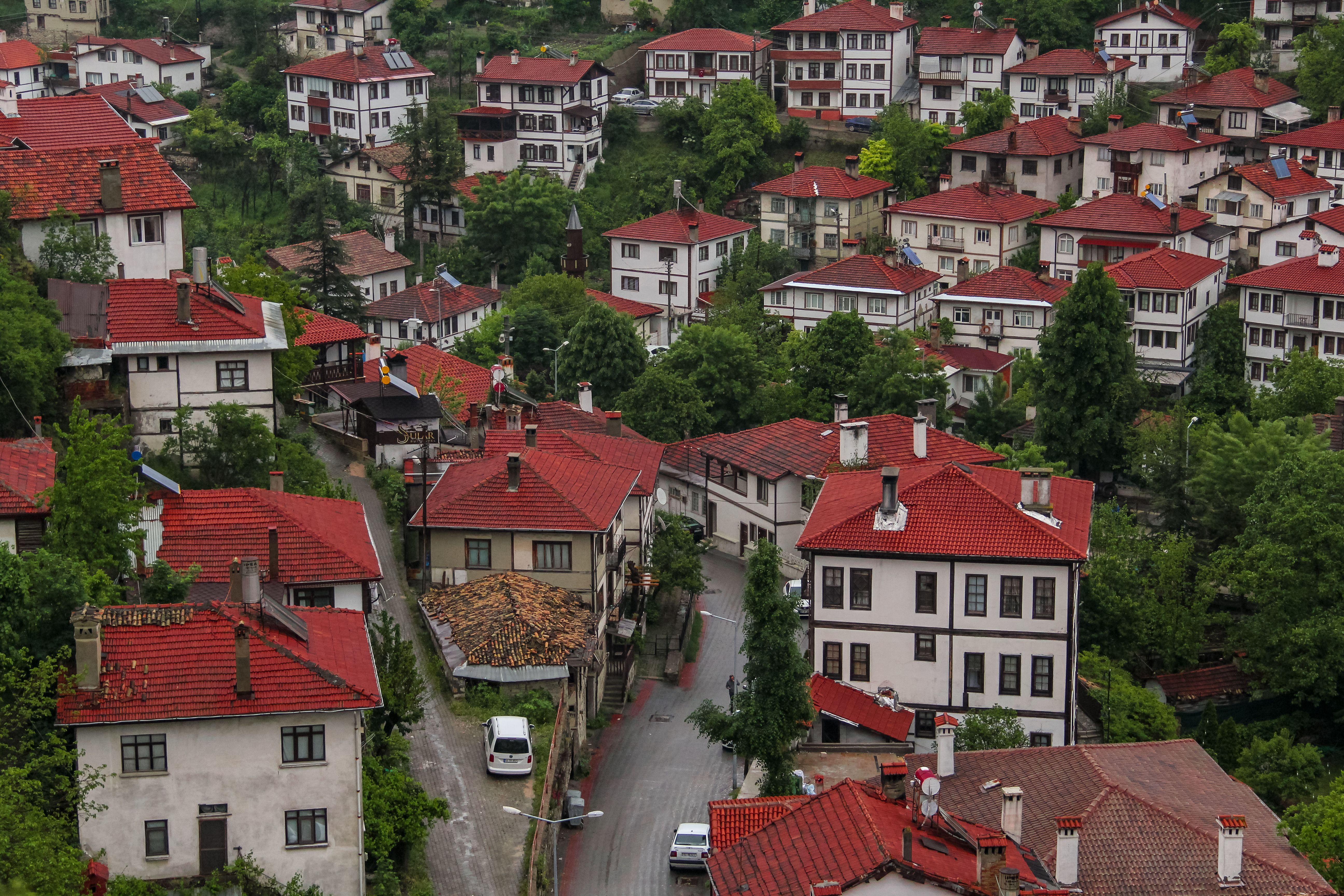 Traditional Ottoman wooden houses with overhanging cumba balconies in Safranbolu old town at golden hour, Turkey, cobblestone streets with historic architecture