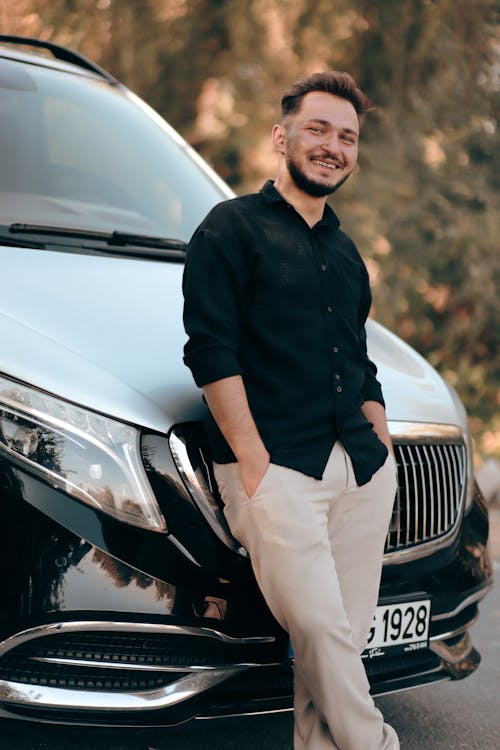 Smiling Man Leaning on a Car