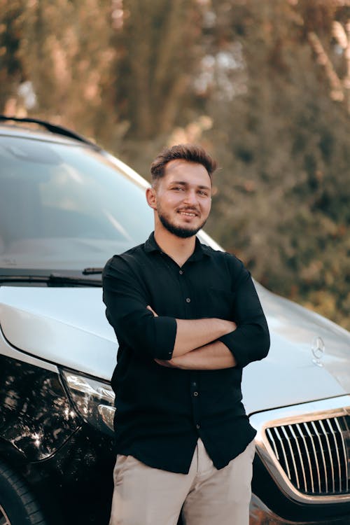 Confident Man Standing by the Car