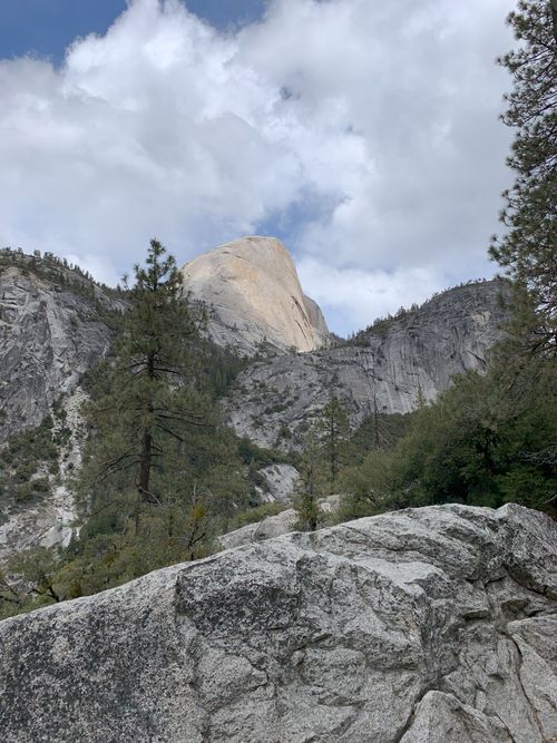 Free Scenic view of Half Dome in Yosemite Valley with granite cliffs and pine trees. Stock Photo