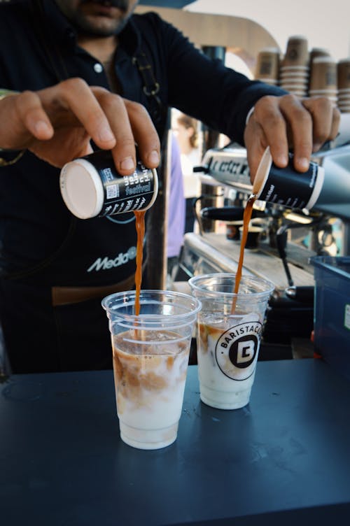 Barista Pouring Coffee into Disposable Cups