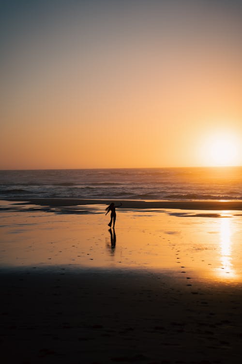 Woman on the Beach at Sunset