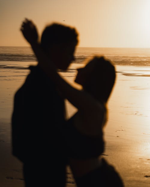 Embracing Couple on Beach at Sunset