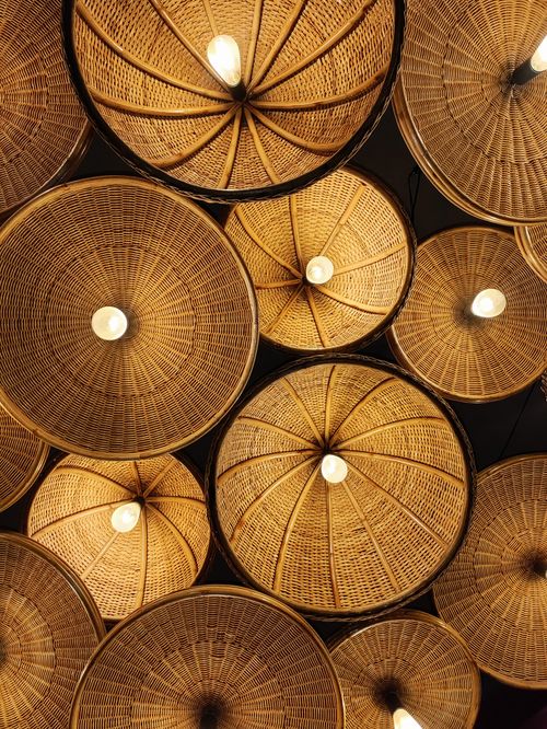 Free A stunning arrangement of glowing wicker lamps hanging indoors, creating a warm ambiance. Stock Photo