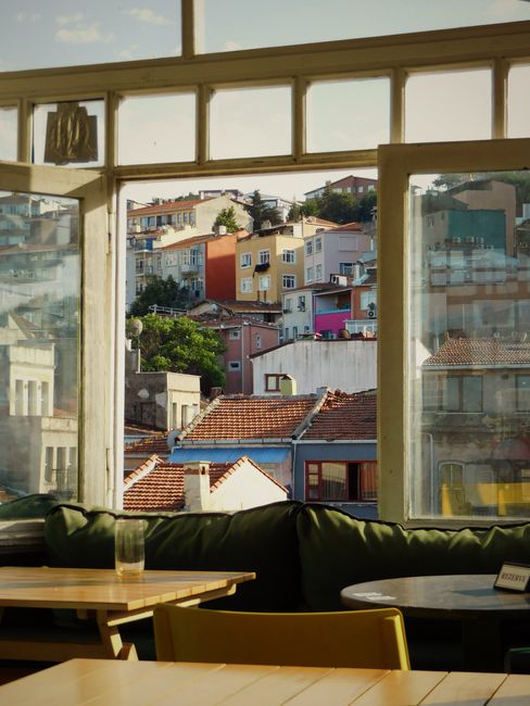 Captivating view through a window of colorful Istanbul homes, showcasing vibrant urban architecture.