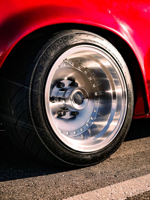 Free Detailed view of a polished aluminum car wheel and tire on a sunny day. Stock Photo