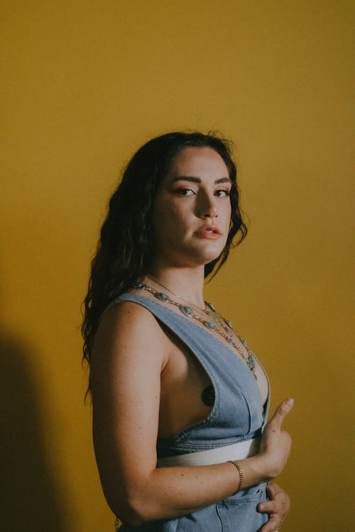 Young Woman in Denim Top Posing in Studio