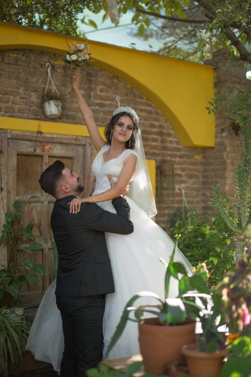 Groom Holding the Bride in the Air 