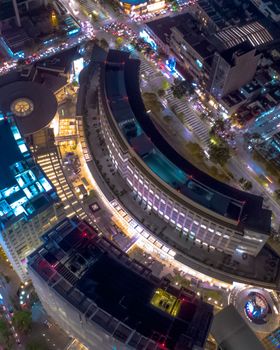 Stunning aerial view of Mexico City's vibrant urban architecture at night, featuring illuminated buildings and bustling streets.