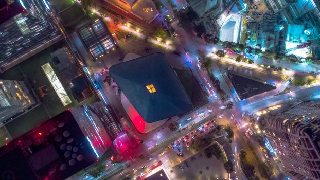 Drone shot capturing vibrant city lights and architecture in Mexico City at night.