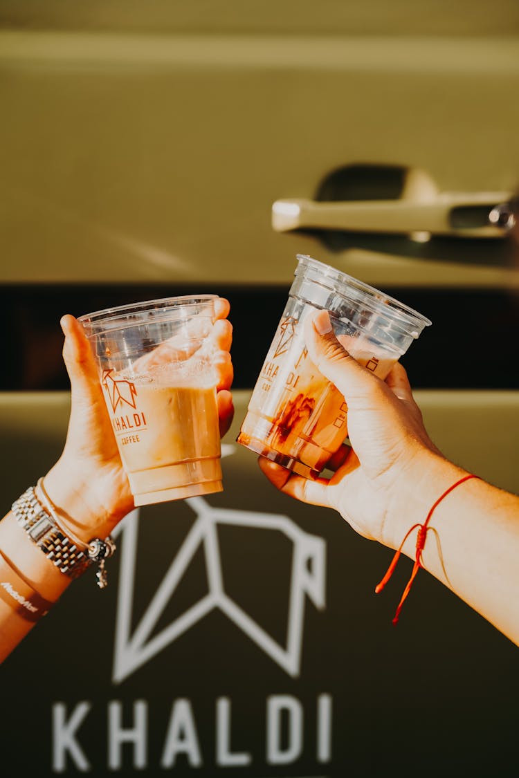 Women Hands Holding Cups Of Coffee