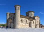 Romantic Romanesque church in Frómista, Spain, under a vibrant blue sky.