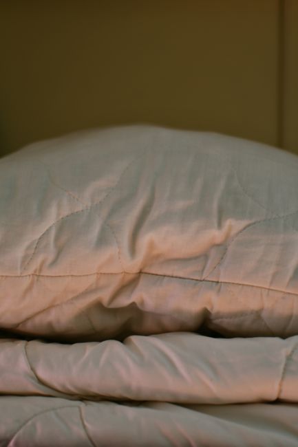 Pillow neatly arranged on a made bed