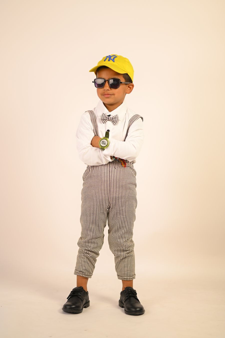 Young model in checked trousers and a bow tie