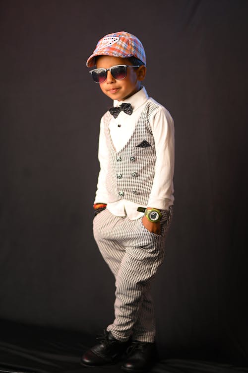 Little Boy in Sunglasses and Suit Posing in Studio