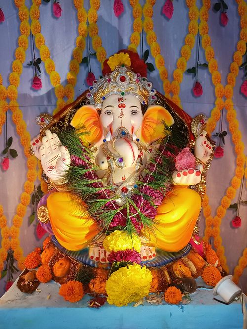 Free A colorful ornamented Ganesha idol at a decorated altar in Mumbai, India. Stock Photo