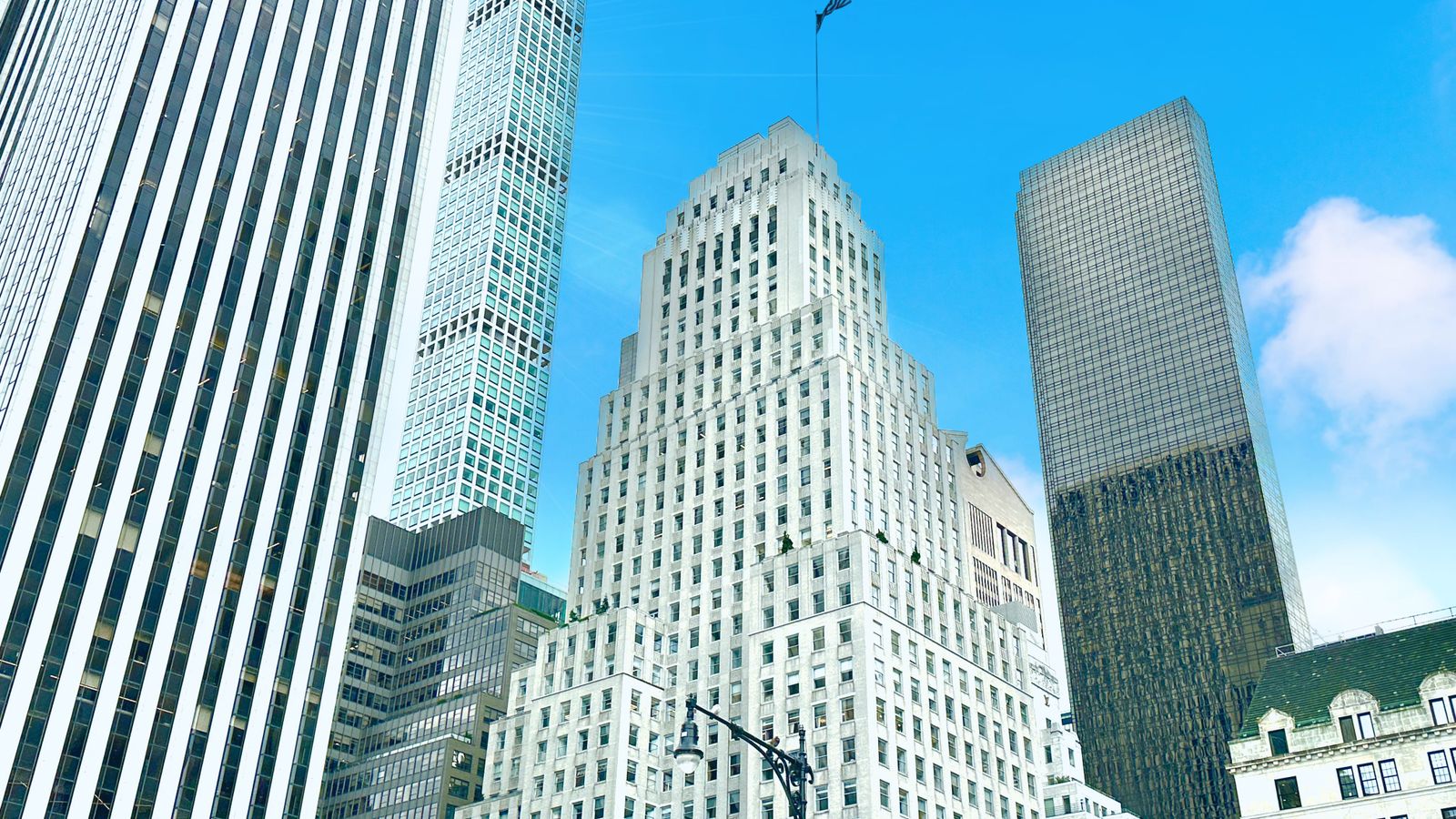 A stunning view of skyscrapers against a bright blue sky in Manhattan's downtown area.