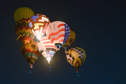 Hot-Air Balloons Flying in Night Sky