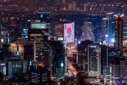Vibrant night skyline of Seoul featuring illuminated skyscrapers and urban landscape.