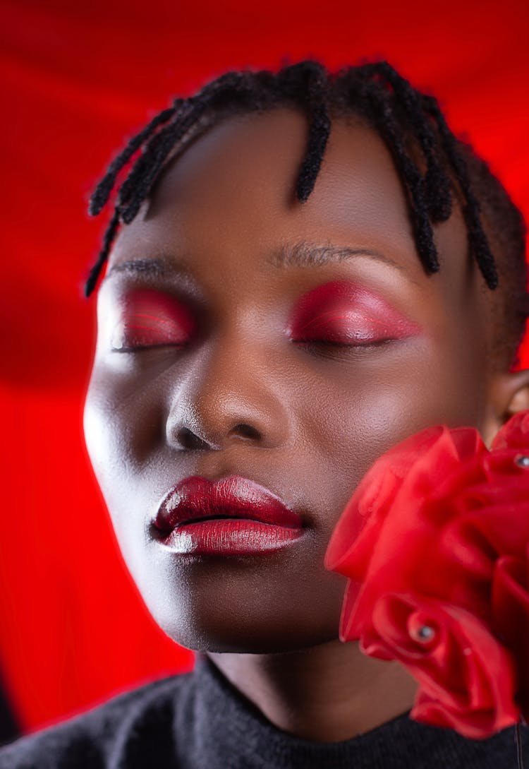 Portrait Of African Woman In Front Of Red Background