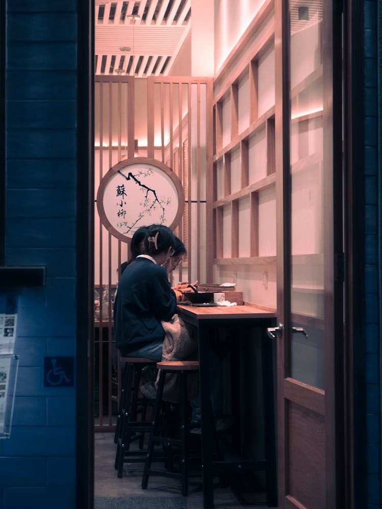 People Sitting By Table In Office