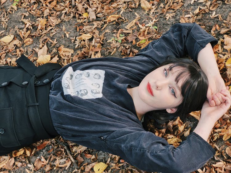 Cute Young Woman Lying On The Ground