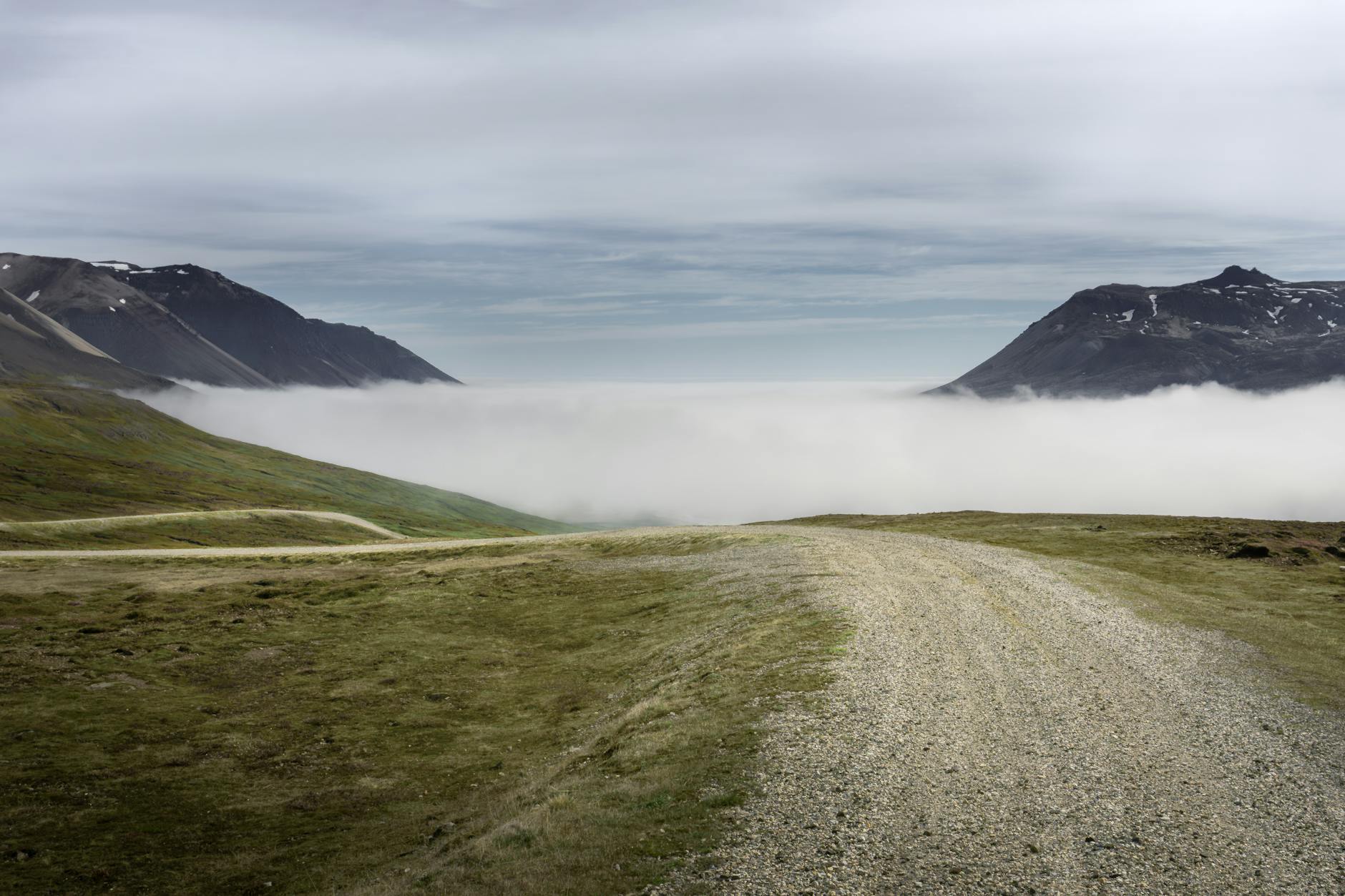 Road Leading to a Mountain Valley Hidden by Fog