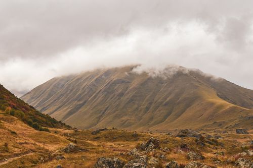 Free Serene mountain landscape with fog and autumn colors in a rocky valley. Stock Photo