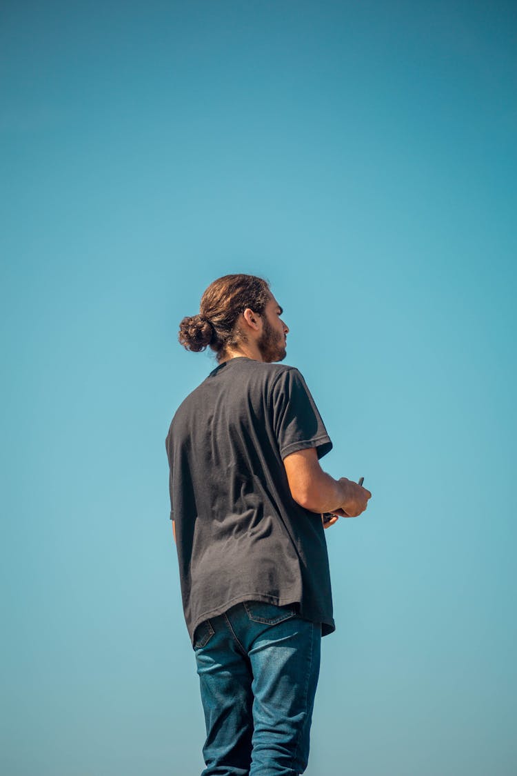 Back Of A Man Standing Against The Sky