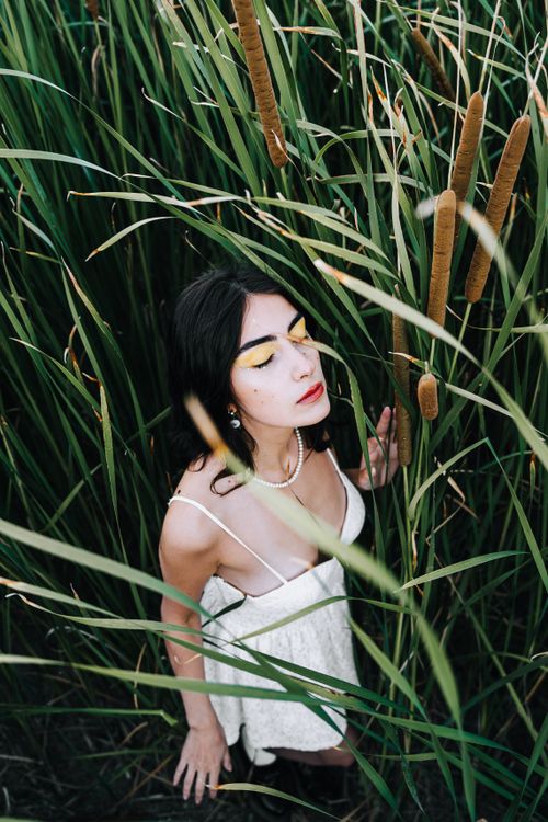Model With Rushes Face Model with Yellow Eye Shadows Wearing a White Summer Dress Posing in ...