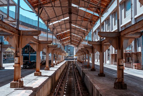 Old and Rusty Steel Roof Over the Tracks at the Railway Station