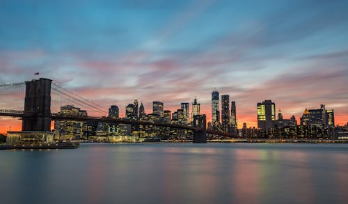 View of the Brooklyn Bridge and Buildings in New York City at Sunset
