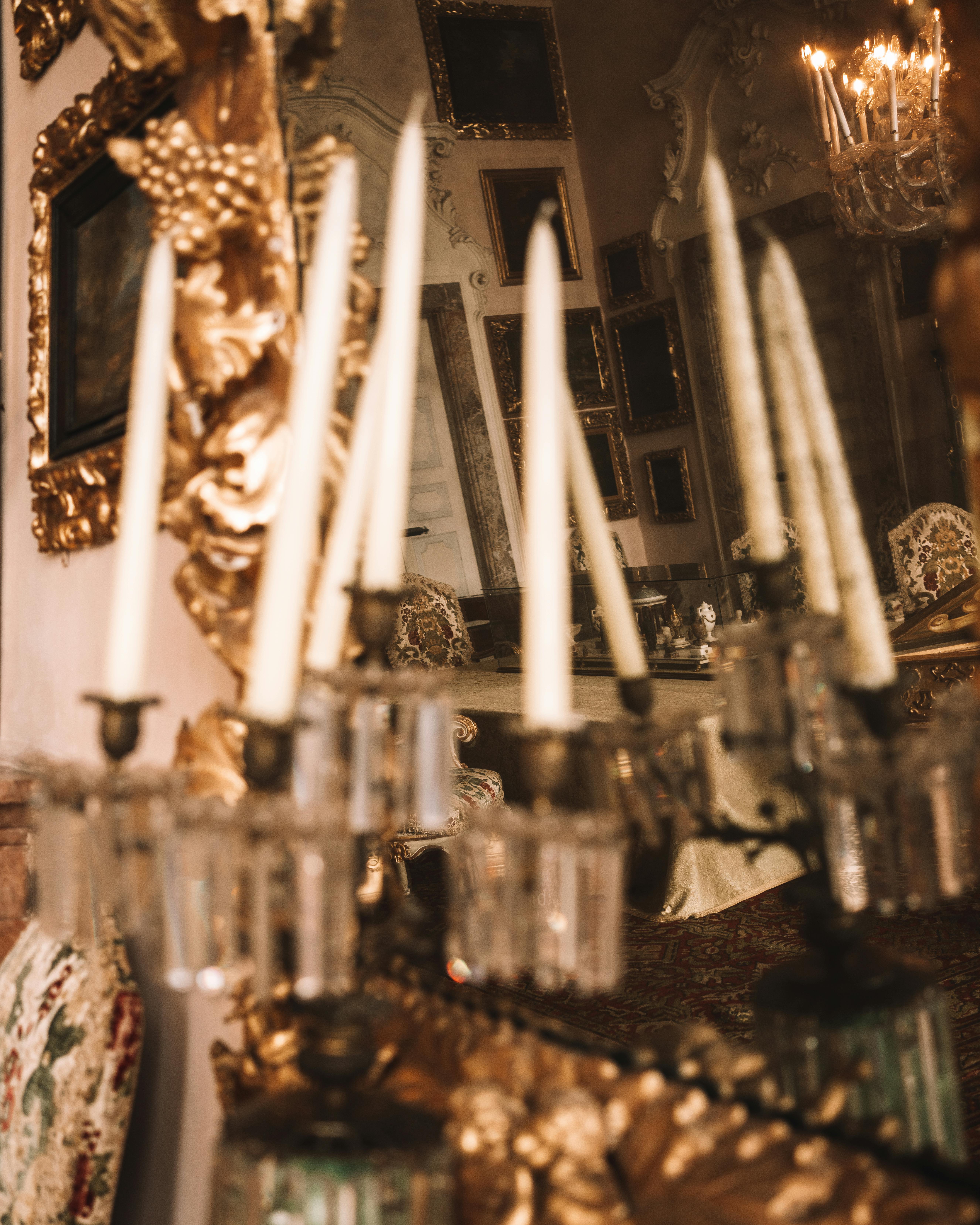 Elegant interior view of a candlelit Italian palace room showcasing ornate details and antique decor.