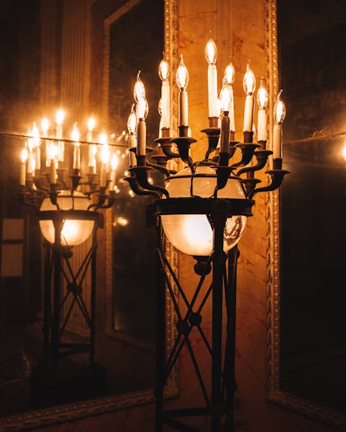 Chandeliers with Lamps by Wall in Darkness