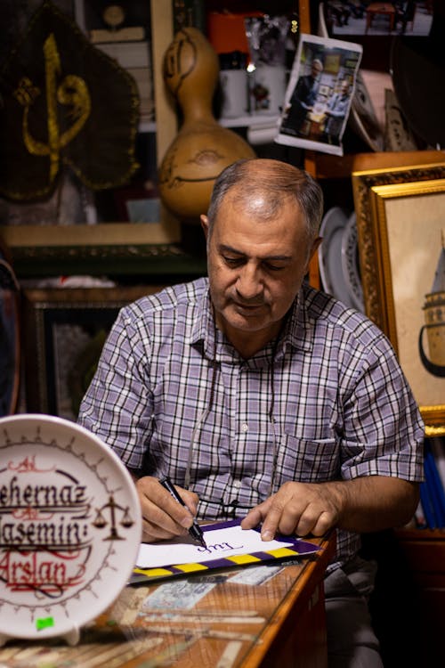 Man Writing on Paper 