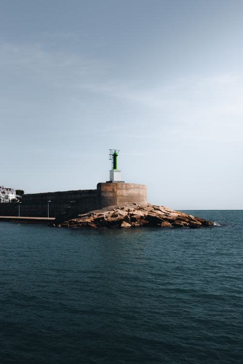 Free A picturesque lighthouse on the coast of Peñíscola, Spain, under a clear blue sky. Stock Photo
