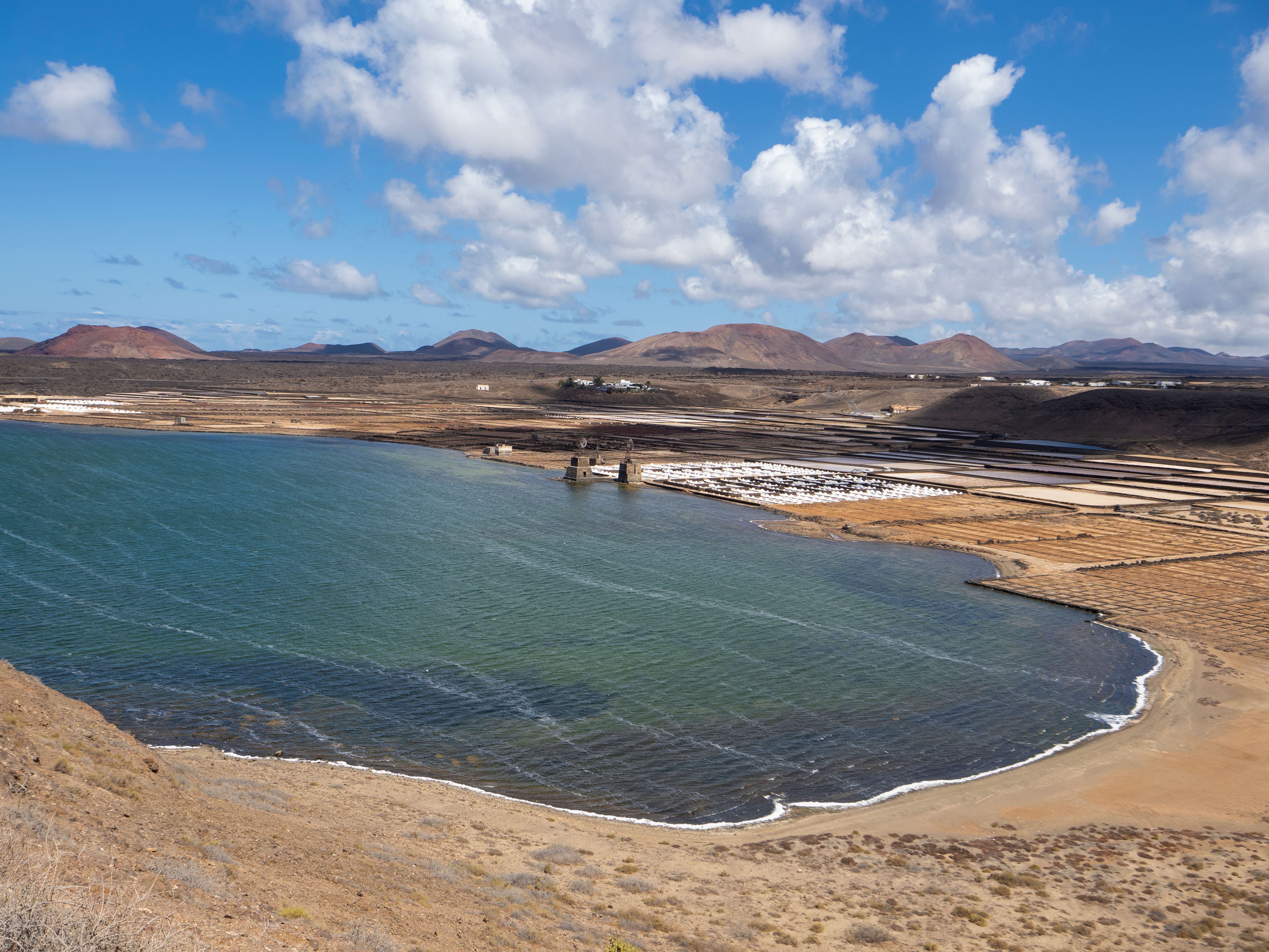 A scenic view of Lanzarote coastline highlighting salt flats and volcanic landscape.